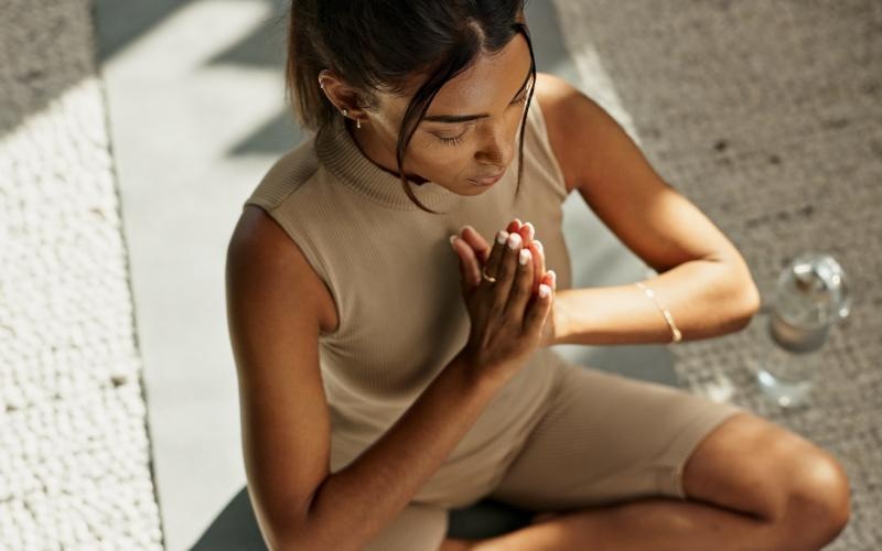 a person sitting on a yoga map