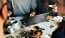 people sitting at a table with coffee and food