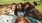 a group of people sitting on the grass