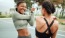 two women stretching outside